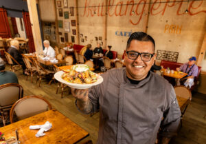 Chef Jorge Flores with his Peach Panzanella with Costeaux Bakery bread at the Healdsburg bakery, Friday, June 30, 2023. (John Burgess / The Press Democrat)