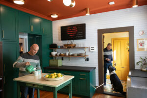 “The more we peeled back the layers, the more we wanted to know about the house,” says Corey Rawdon of the home he shares with his husband, Noah Jeppson, and their dog, Bash. Pictured is the transformed kitchen with a customizable, vintage-style message board. (Eileen Roche)