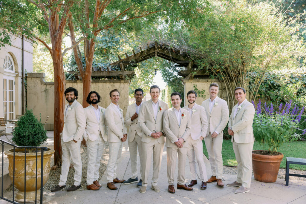 The couple's groomsmen wore pale-colored suits to suit a casual, afternoon reception. (Kathryn White)