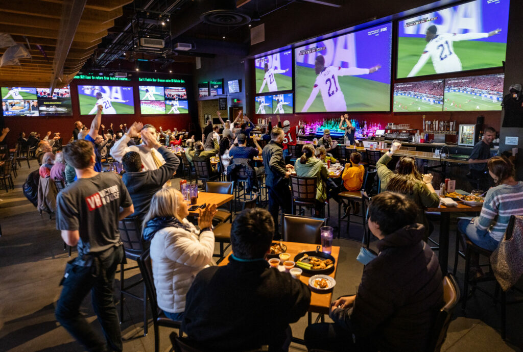 Soccer fans celebrate a U.S. goal in the first half against Wales in the first round of the World Cup at the Victory House in Epicenter Santa Rosa Monday, November 21, 2022. (John Burgess / The Press Democrat)