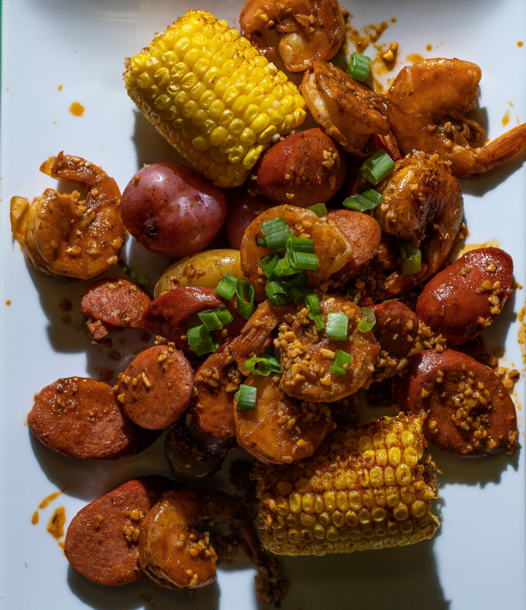 Mahkaila Gans, owner of Smackin' Soul Food, prepares an order of shrimp and sausage boil for her popup takeout at the Veterans Memorial Building on Maple Ave. on Tuesday, June 6, 2023, in Santa Rosa. (Chad Surmick / The Press Democrat)