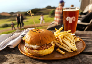 Farm Beef Burger with Fries and a beer for a casual meal at sunset on the back deck of the Sea Ranch Lodge Restaurant Friday, February 21, 2025, on the northern Sonoma coast. (John Burgess / The Press Democrat)