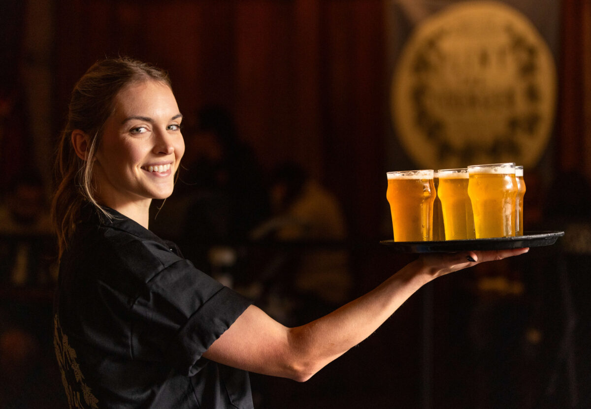 Server Stevye Wilhite with a tray of Pliny the Younger triple IPA Friday morning March 21, 2025 at the Russian River Brewing Co. in downtown Santa Rosa. (John Burgess / The Press Democrat)
