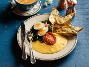 The Market Plate with sautéed spinach, copper, roasted tomatoes, hard boiled egg creamy polenta and cambozola toast from Willow Wood Market Cafe Wednesday March 6, 2024, in Graton. (John Burgess/The Press Democrat)