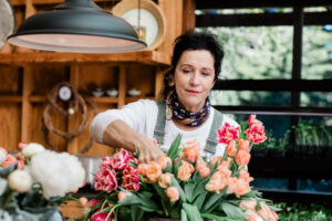 Nicole Buttitta prepares flower bouquets at her potting shed in Sebastopol. (Eileen Roche / Sonoma Magazine)
