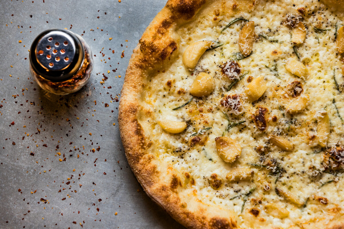 The Nico Pie with olive oil, mozzarella, roasted garlic cloves, fresh rosemary, cracked black pepper and shaved Parmesan from PizzaLeah Wednesday, April 16, 2025, in Windsor. (John Burgess / The Press Democrat)