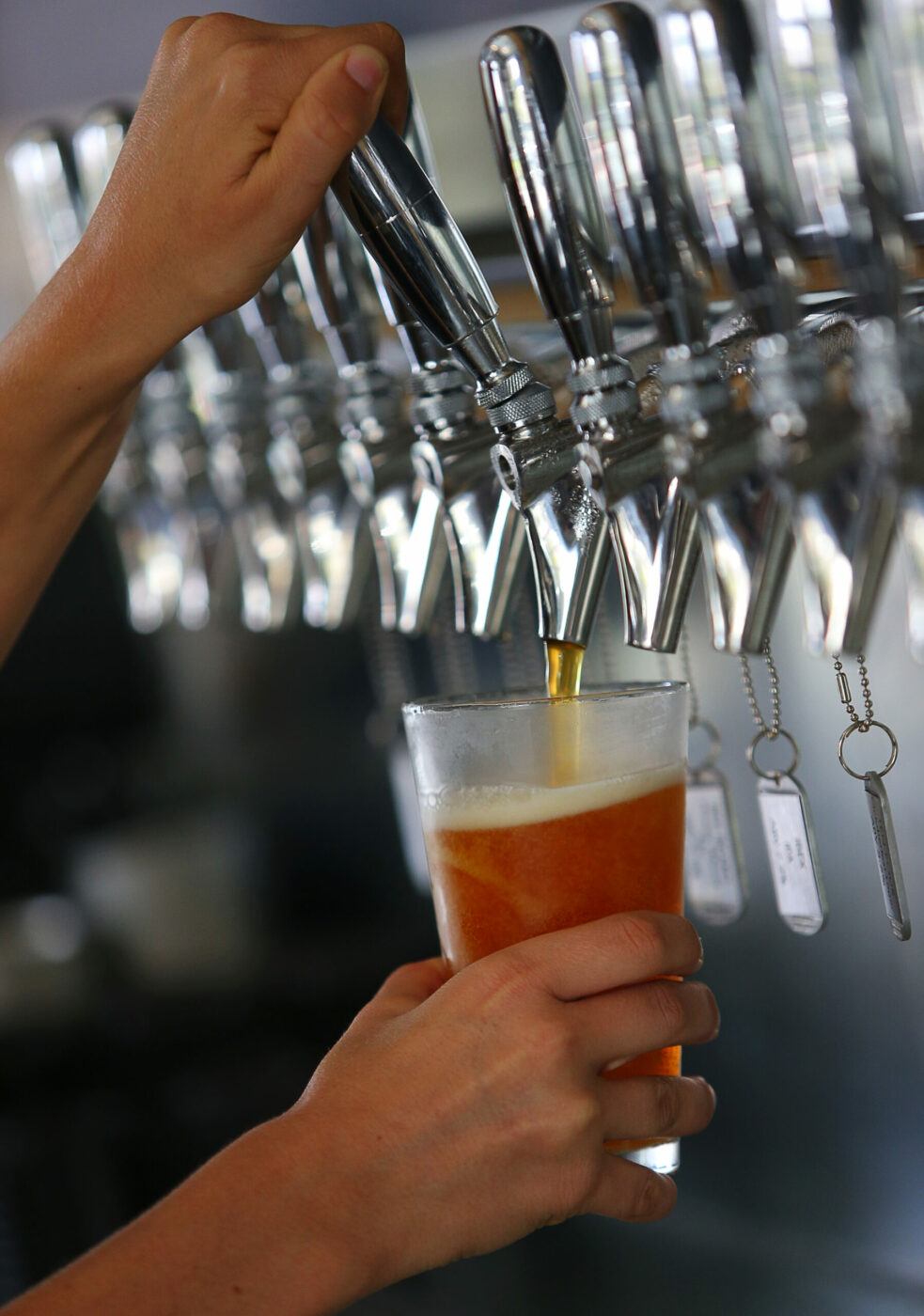 A glass of beer is dispensed from a tap at Crooked Goat Brewing, in Sebastopol, on Wednesday, October 12, 2016. (Christopher Chung/ The Press Democrat)