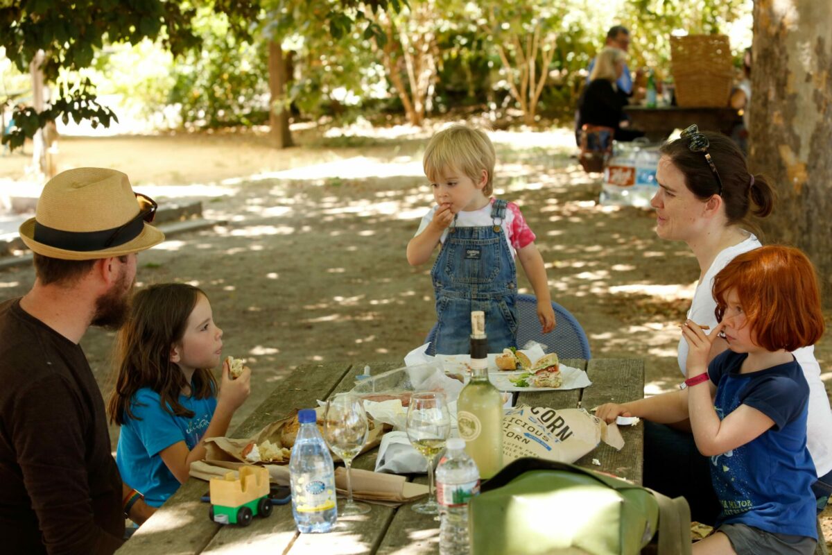 The Noble family from San Francisco, from left, father Jeremy, Evelyn, 7, Ian, 2, mother Elizabeth and Cora, 5, enjoy a picnic in the shade at Preston Farm and Winery in Healdsburg, California, on Sunday, August 13, 2017. (Alvin Jornada / The Press Democrat)