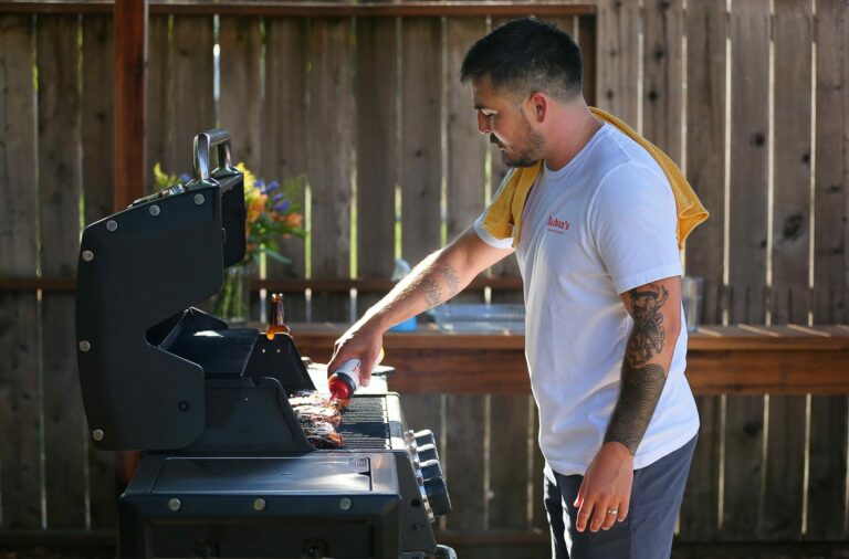 Justin Gill adds his Bachan's Japanese Barbecue Sauce onto grilled rib-eye in Santa Rosa on Wednesday, Sept. 11, 2019. (Christopher Chung/ The Press Democrat)