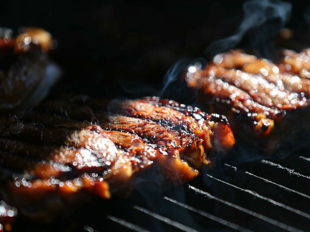 Bachan's grilled rib-eye, made by Justin Gill, cooks on a barbecue in Santa Rosa on Wednesday, Sept. 11, 2019. (Christopher Chung/ The Press Democrat)