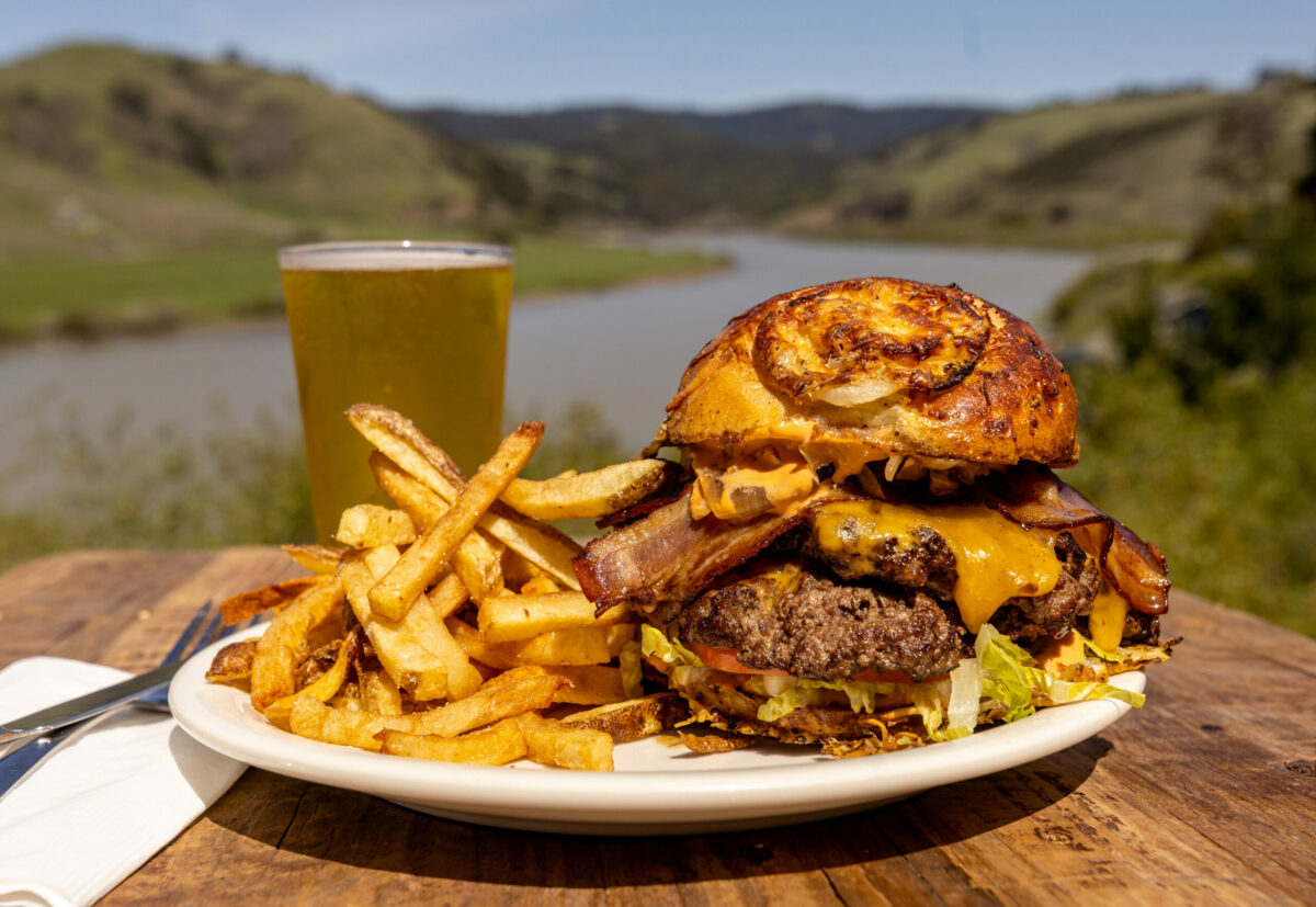 The Smashburger and a side of fries from Jilly’s Real Food Roadhouse Friday, April 4, 2025, overlooking the Russia River on Highway 1 near Jenner. (John Burgess / The Press Democrat)