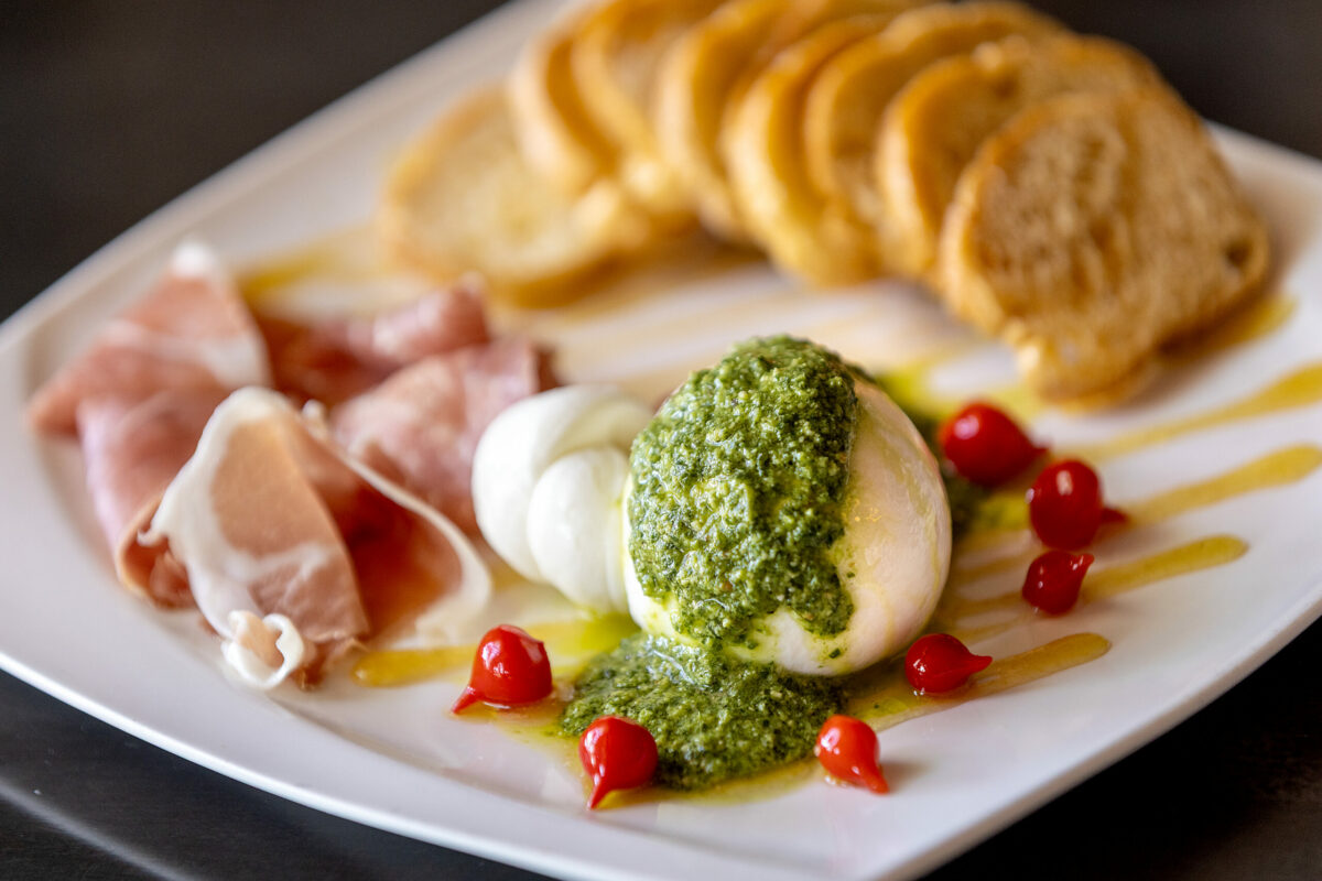 Grata Burrata with preserved lemon honey, pesto, pickled peppers, crostini and prosciutto from Grata Italian Eatery chef/owner Eric Foster Thursday, May 8, 2025, in Windsor. (John Burgess / The Press Democrat)