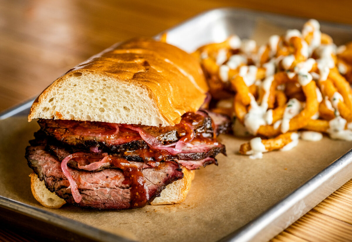 Snake River Farms Tri-tip Sandwich with a side of Curly Fries with garlic chive aioli from Stateline Road Smokehouse Friday, August 23, 2024, in Napa. (John Burgess / The Press Democrat)