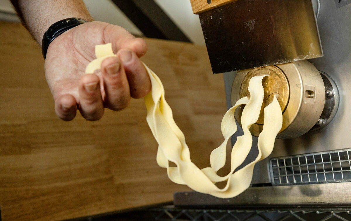 Chef Ian Marks uses an pasta making machine for their daily pappardelle and 4 other varieties at Acre Pasta, Friday, May 30, 2025 in Sebastopol’s Barlow District. (John Burgess / The Press Democrat)