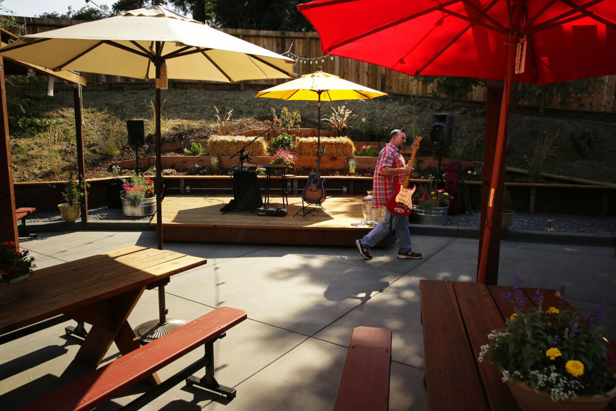 Tommy Rox setups to play live music at the newly renovated Twin Oaks bar's backyard patio Penngrove on Thursday, July 17, 2014. (Conner Jay/The Press Democrat)