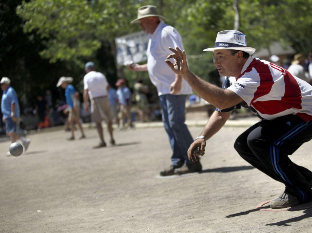 Mark Greenberg throws a boule, a metal ball, towards a jack, a small wooden ball, while competing in the men's doubles U.S. Petanque Federation's national championships hosted by the Valley of the Moon Petanque Club on Sunday, May 19, 2013 in Sonoma, California. (BETH SCHLANKER/ The Press Democrat)