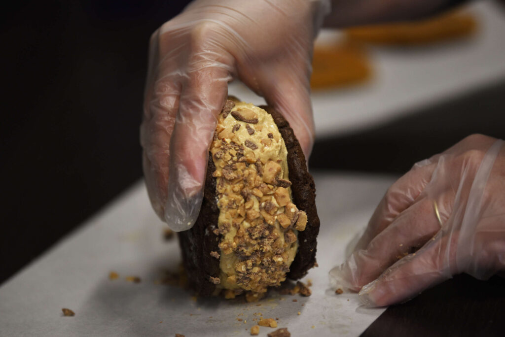 Coffee ice cream and a crushed Heath bar is prepared for a customer at Squatch's Gourmet Ice Cream Sandwiches and Coffee in Rohnert Park on Saturday, July 10, 2021. (Erik Castro/for The Press Democrat)
