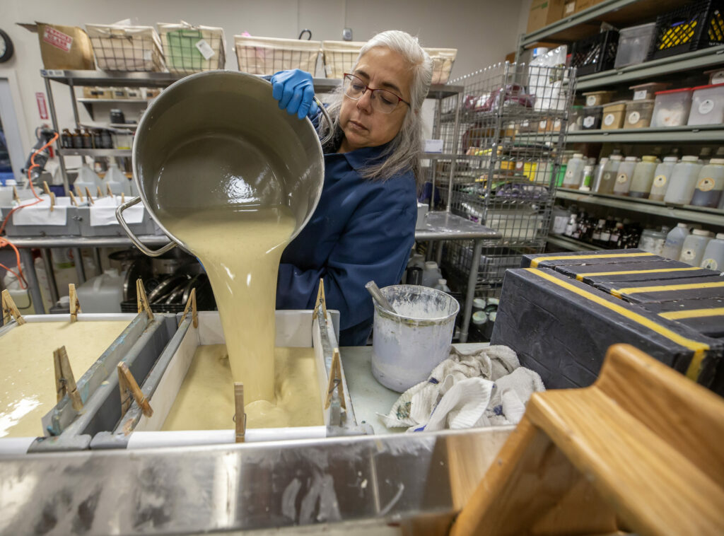 Emma Mann, Soap Cauldron owner, mixes up a batch of lavender soap while working in her production facility Monday in downtown Penngrove, November 28, 2023. (Chad Surmick / The Press Democrat)