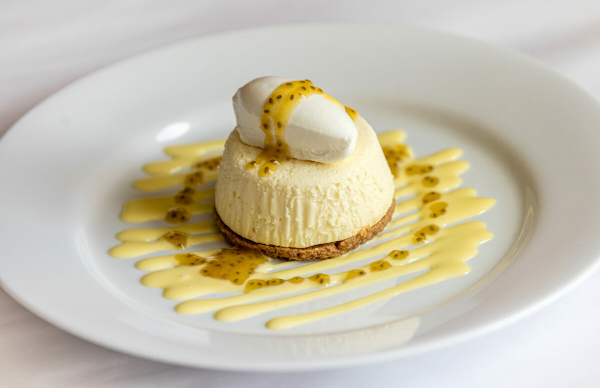 Passion Fruit Cheese Cake with whipped cream and vanilla bean sauce from Terrapin Creek Cafe Restaurant Friday, May 30, 2025, in Bodega Bay. (John Burgess / The Press Democrat)