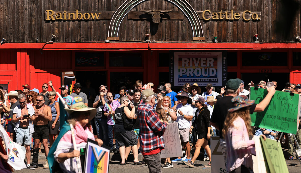 Parade watchers gather in front of the Rainbow Cattle Company during the Russian River Pride Parade and Festival in Guerneville, Saturday, Sept. 21, 2024. (Kent Porter / The Press Democrat)