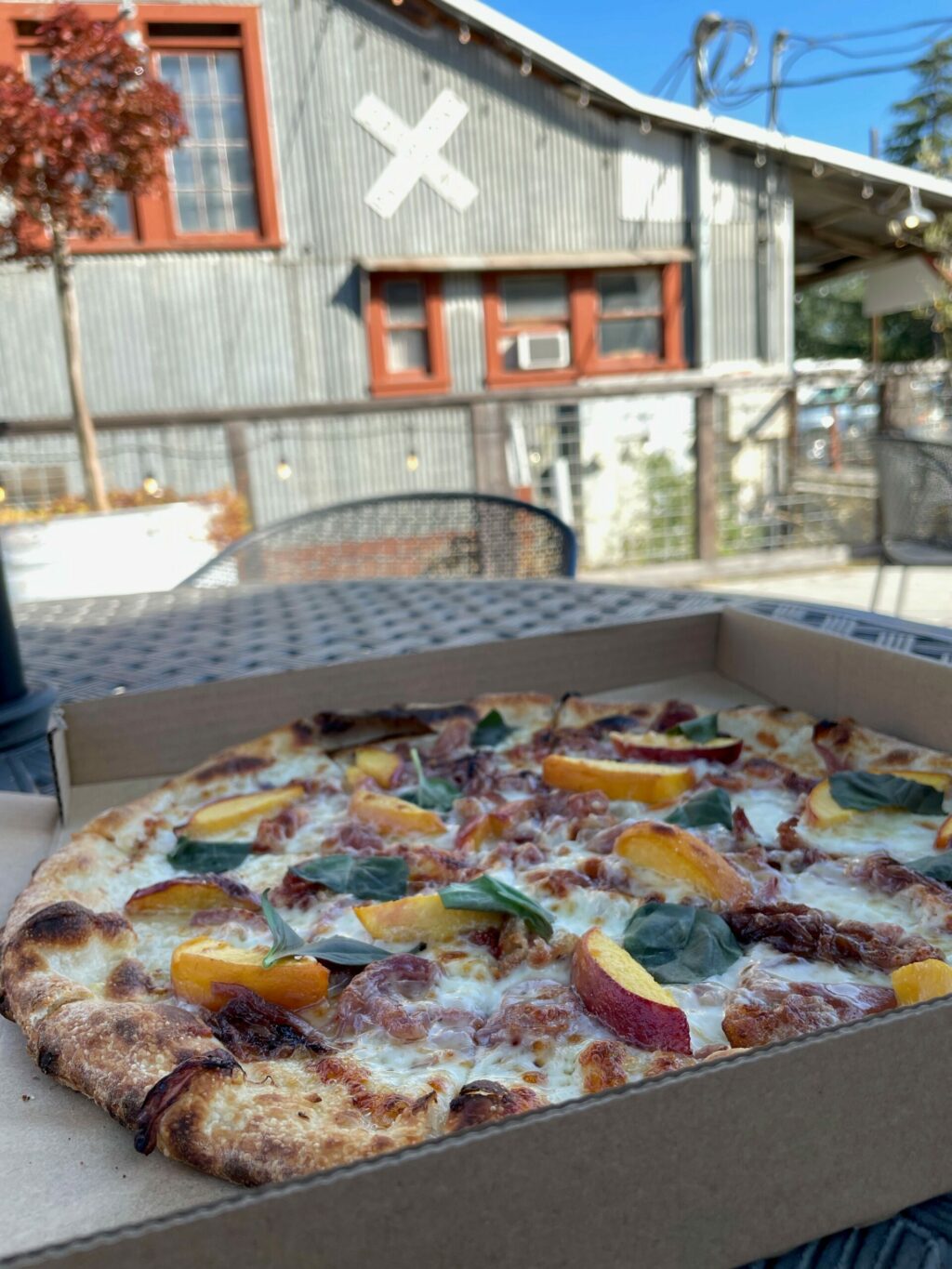 The bianco pizza at Penngrove Market topped with pancetta and local peaches. (Peter Posert)
