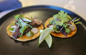 Tacos de Asada topped with grilled skirt steak, huitlacoche cream and roasted scallions wrapped in a homemade corn tortilla at chef Carlos Mojica's dinner pop-up at Aroma de Cafe in Santa Rosa. (Heather Irwin/The Press Democrat)
