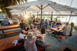 Group tables on the large patio at sunset at the Waterhawk Lake Club Thursday, August 14, 2025, in Rohnert Park. (John Burgess / The Press Democrat)