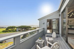 The deck boasts views of the ocean and a nearby golf course. (Open Homes Photography)