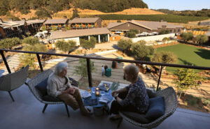 Three stories up at Andys Beeline Rooftop, friends Barbara Epstein, left, and Liz Loebel catch up during the formal opening of Appellation Healdsburg, Friday, Sept. 12, 2025. (The Press Democrat)