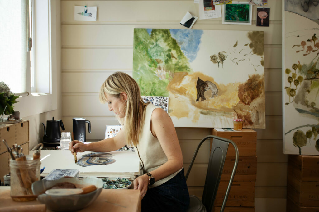 Artist Cristina Hobbs working in her converted-farmhouse studio. (Eileen Roche / for Sonoma Magazine)