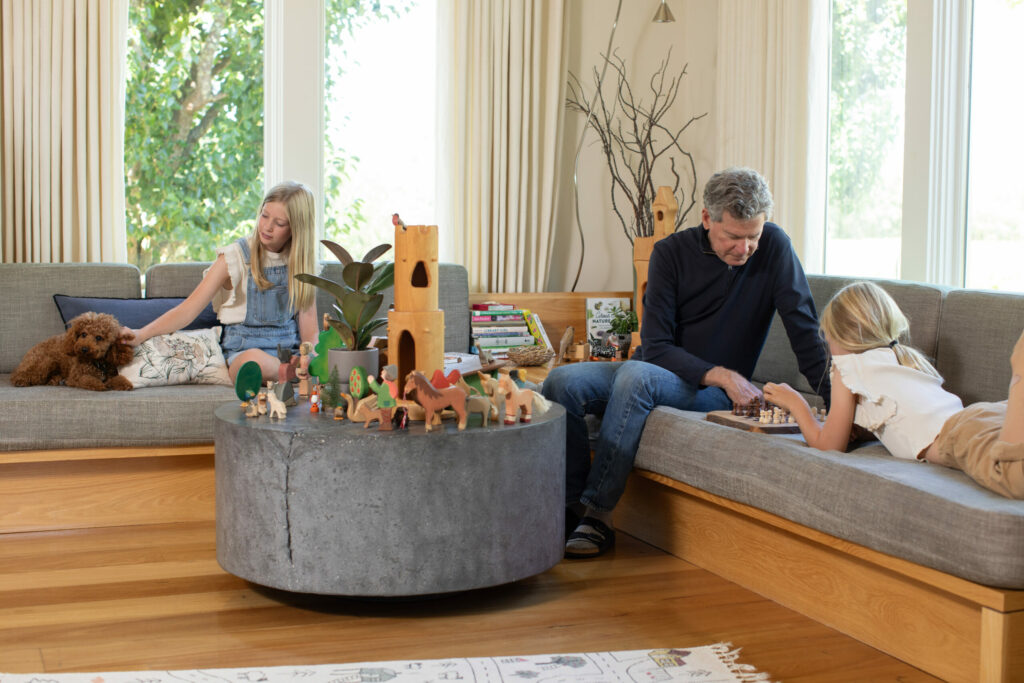 Winemaker Paul Hobbs and daughters Sophia and Louisa lounge and play in their west county home. (Eileen Roche / for Sonoma Magazine)