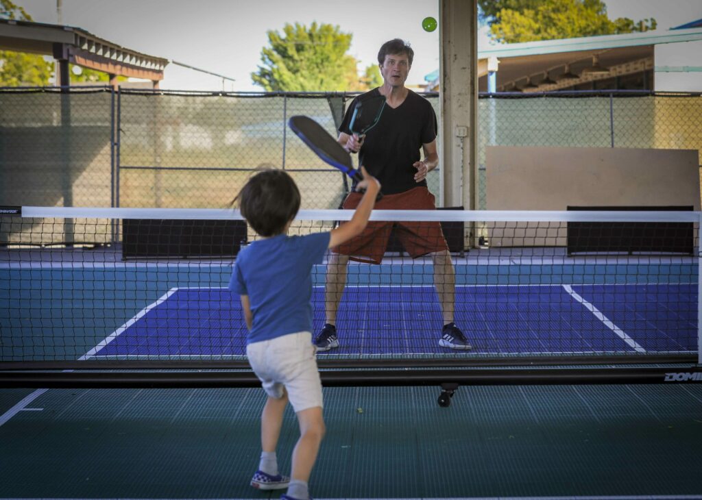 John Malanga plays pickleball with his son, Matteo, at the Petaluma Fairgrounds Pickleball courts on Monday, May 19, 2025. (Crissy Pascual / Petaluma Argus-Courier)