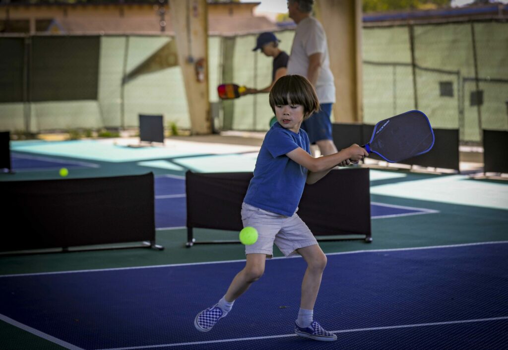 Matteo Malanga hits some balls with his dad, John, at the Petaluma Fairgrounds Pickleball courts on Monday, May 19, 2025. (Crissy Pascual / Petaluma Argus-Courier)