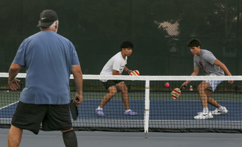 Philip Liu and Elliott Blue, both 17-year-old high school students in Petaluma, play a pickleball match at Lucchesi Park on Thursday, August 24, 2023. (Crissy Pascual / Petaluma Argus-Courier)