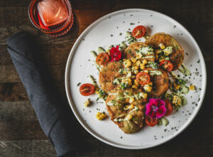 Fried Green Tomatoes with roasted corn, toybox tomatoes, avocado cream and fried basil at the Grove Speakeasy Thursday, Oct. 9, 2025 in Penngrove. (John Burgess / The Press Democrat)