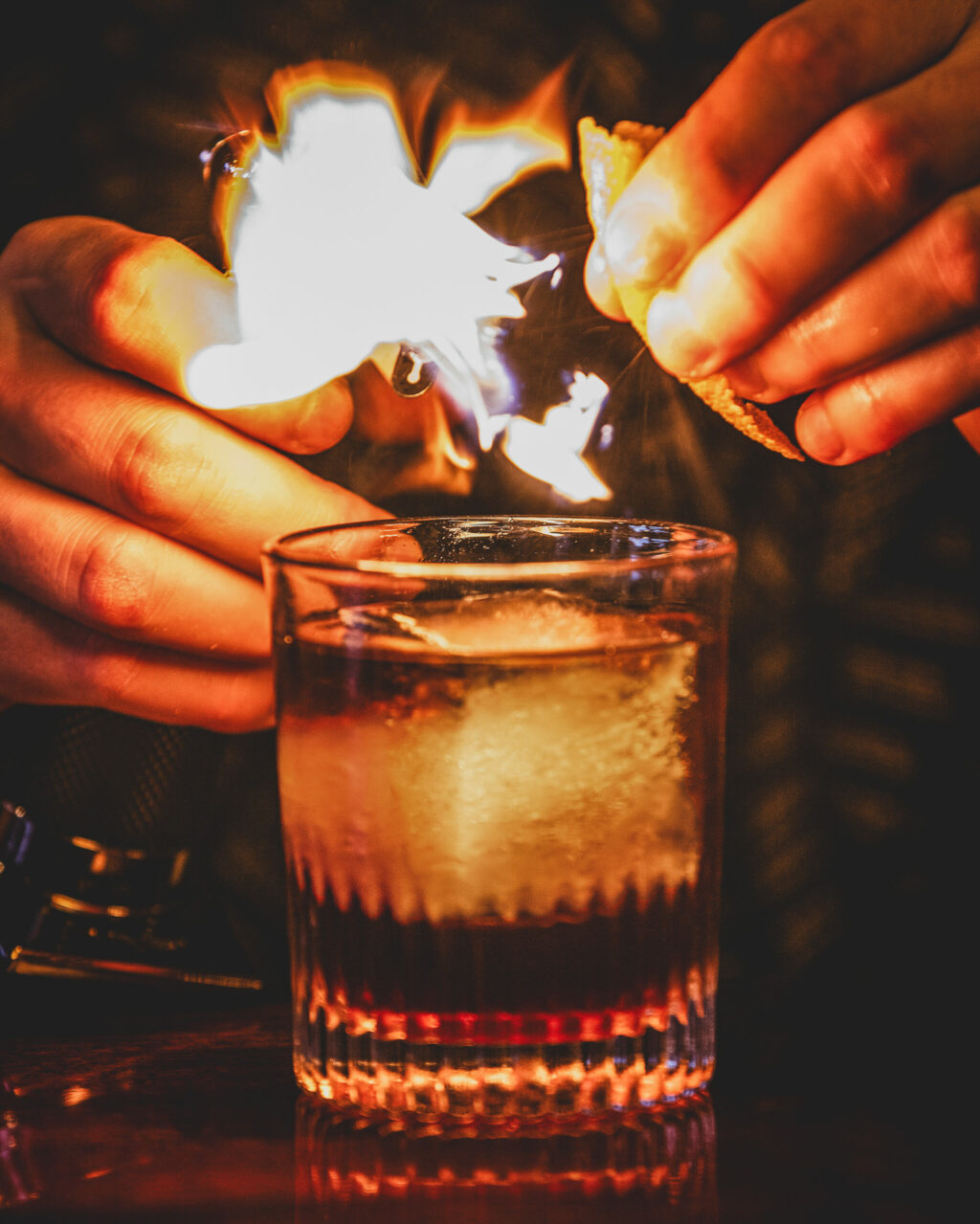 General manager Mike Inglin lights the spray from a squeezed lemon peel over the Grove Speakeasy Whiskey Business cocktail Thursday, Oct. 9, 2025 in Penngrove. (John Burgess / The Press Democrat)