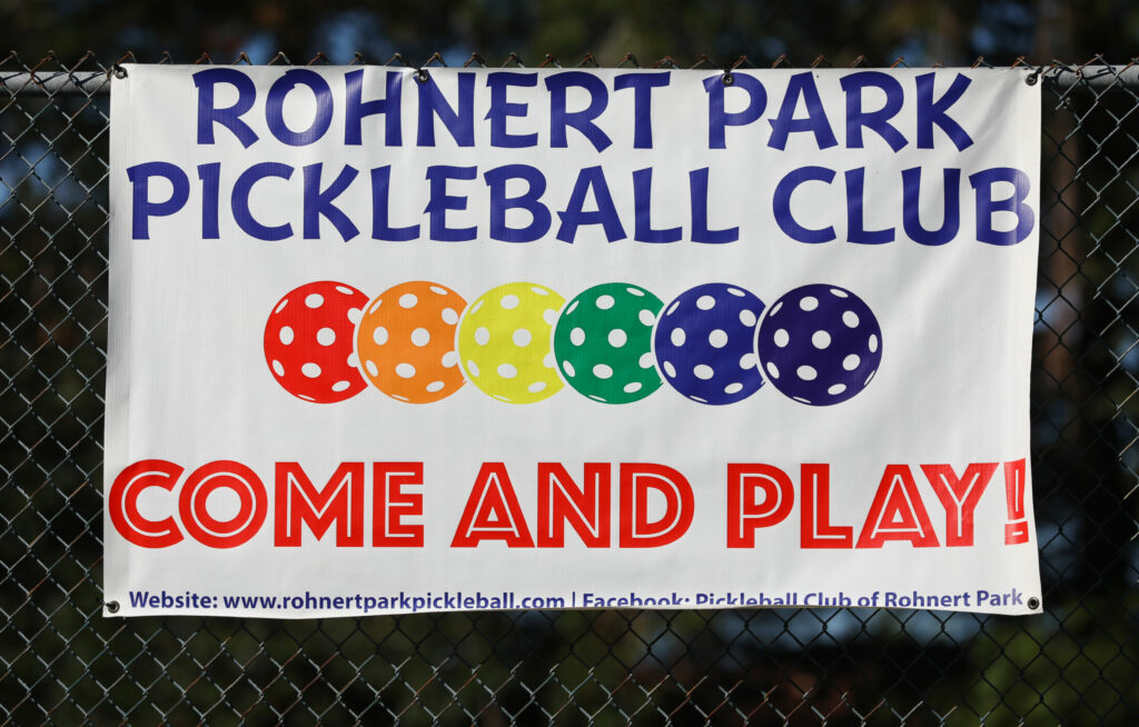 The Rohnert Park Pickleball Club sign hangs along the pickleball court fence at Sunrise Park in Rohnert Park on Monday, October 6, 2025. (Christopher Chung / The Press Democrat)