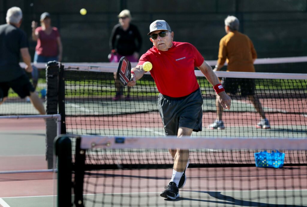 Al Fiori, 83, hits the ball during a game of pickleball at Finley Community Park in Santa Rosa on Thursday, Feb. 27, 2020. (Beth Schlanker / The Press Democrat)