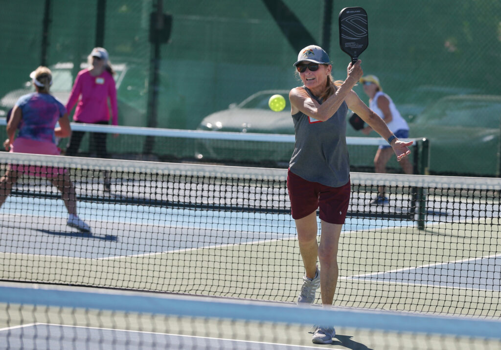 Pam Mason hits a return on the pickleball courts at Airport Health Club in Santa Rosa on Tuesday, July 2, 2024. (Christopher Chung / The Press Democrat)