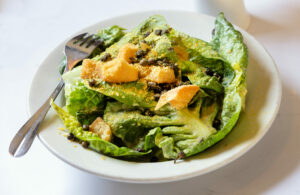 Singing Frogs Little Gems Salad with vegan Caesar dressing, croutons, fried capers and nutritional yeast from Hazel restaurant Thursday, July 10, 2025 celebrating 10 years in Occidental. (John Burgess / Press Democrat)