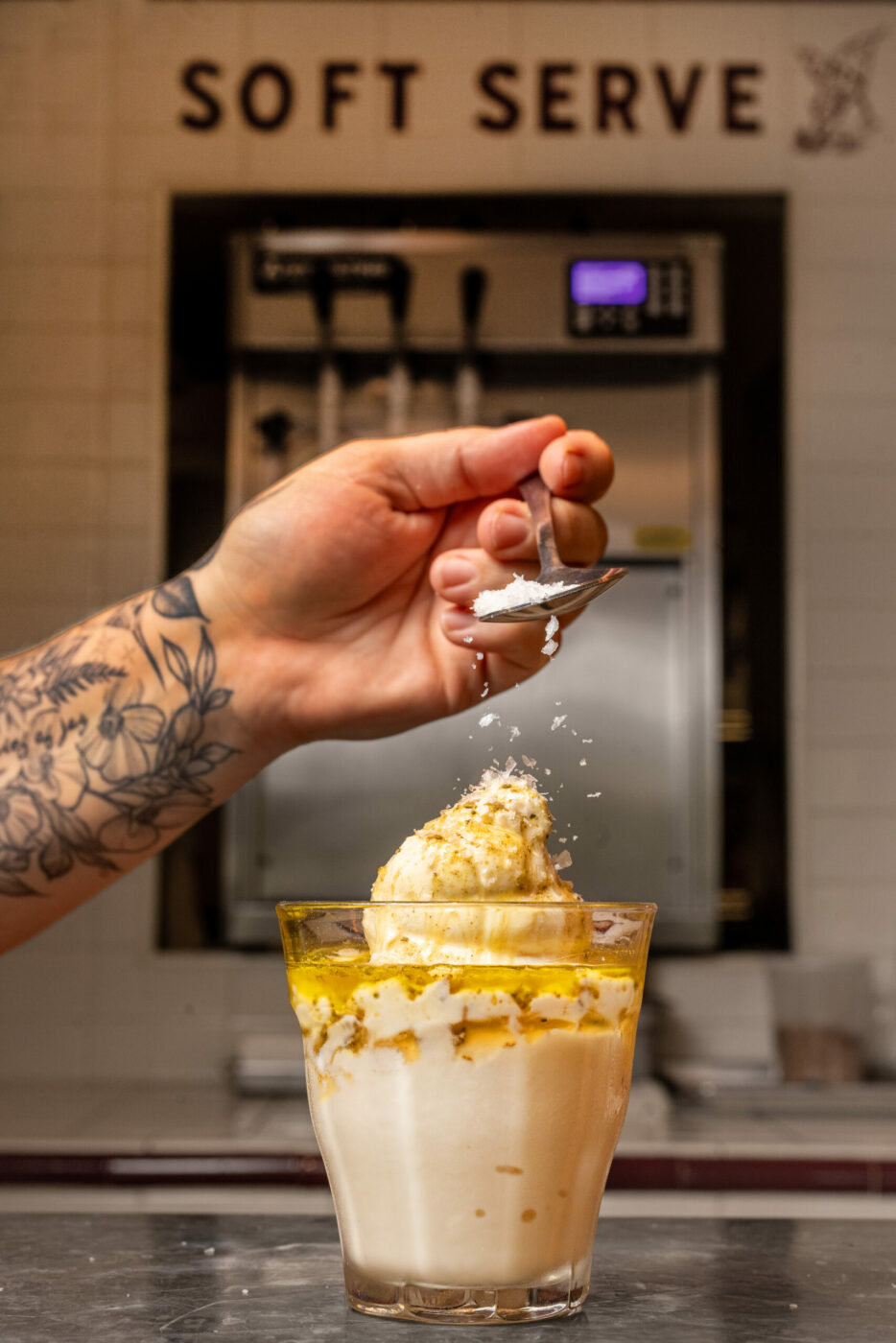 Adding flaky salt to “The Greek” Straus soft serve ice cream drizzled with olive oil at Philo’s hot new restaurant, Jumbo’s Win Win Thursday, August 14, 2025 in the Anderson Valley. (John Burgess / The Press Democrat)