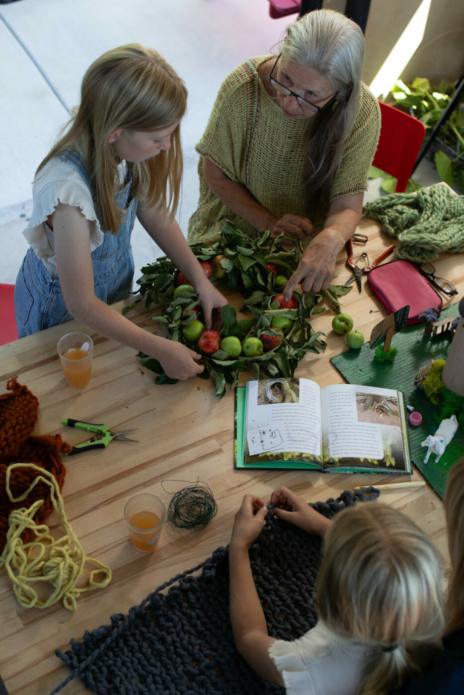 Cristina Hobbs's mother makes wreaths with her grandchildren in the garden outside the potting shed. (Eileen Roche / for Sonoma Magazine)