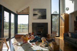 Artwork frames a reading nook in the living room giving the family’s young children a place to relax and reflect. Note the unfinished drywall in the living room reveals the home’s sheep’s wool insulation. (Eileen Roche / for Sonoma Magazine)