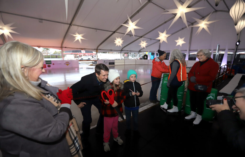 Drew Halter, director of Petaluma Parks and Recreation, poses with his children, Harley and Luke, both 8, at the opening of Luma Ice, the city's first-ever holiday ice skating rink, at the Petaluma Fairgrounds, Friday, December 13, 2024. (Darryl Bush / For The Press Democrat)