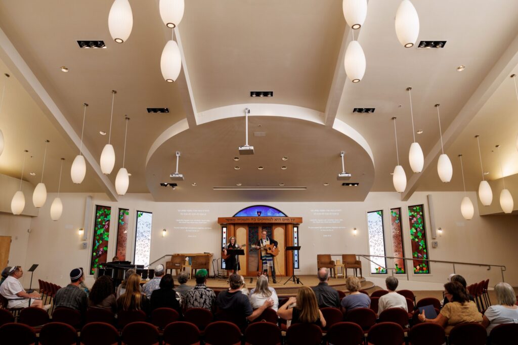 Rabbi Jeremy Morrison and Erica Wisner, Congregation Shomrei Torah’s Erev Cantor, sing during Shabbat at Congregation Shomrei Torah on August 15, 2025. (Abraham Fuentes/For The Press Democrat)