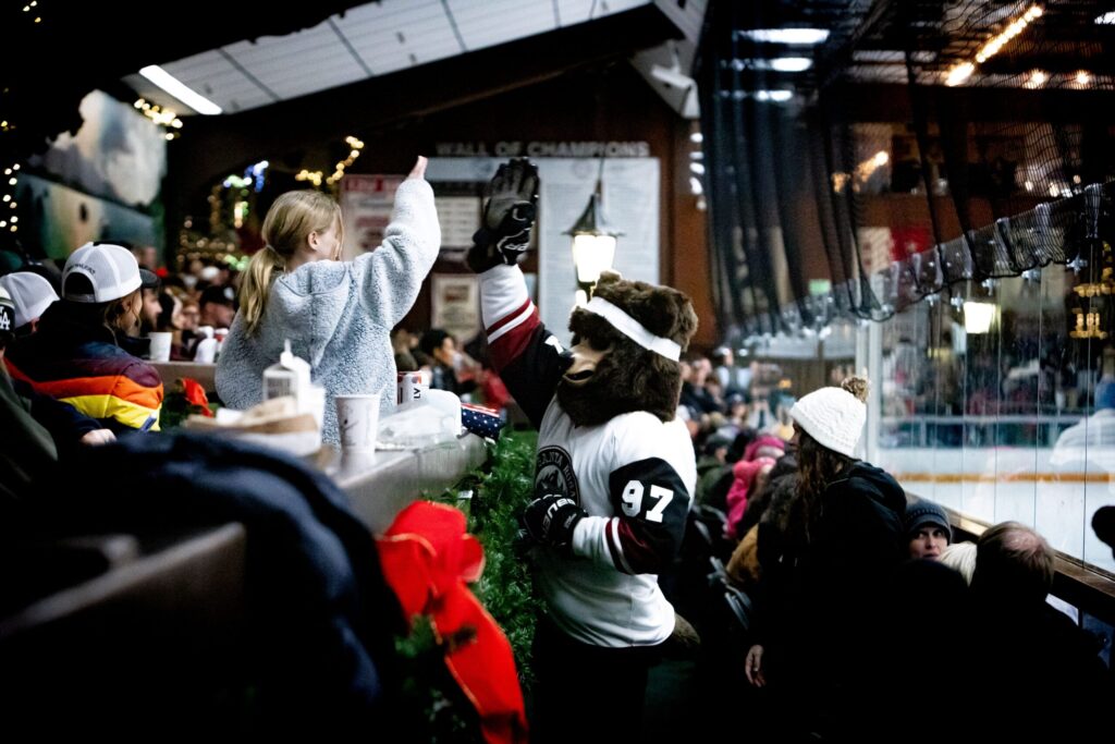 The Santa Rosa Growlers mascot interacts with a fan at Snoopy's Home Ice in Santa Rosa. (Courtesy Andy Lumens)