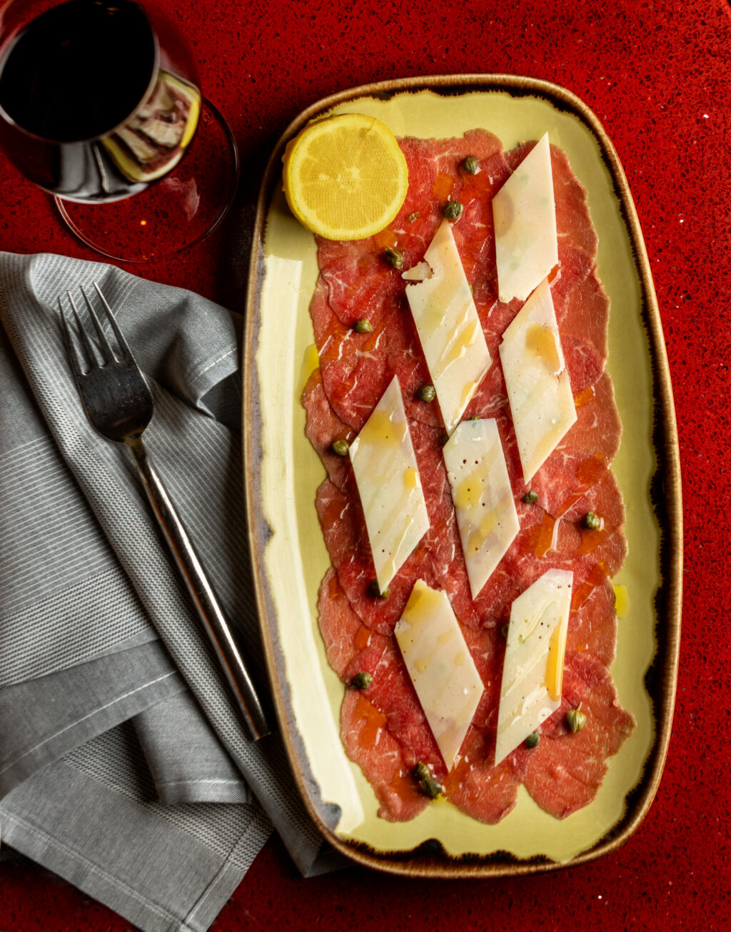 Carpaccio of thinly sliced raw beef, shaved Grana Padano, capers, lemon and EVOO at Baci Cafe and Wine Bar Thursday, Oct. 16, 2025 in Healdsburg. (John Burgess / The Press Democrat)