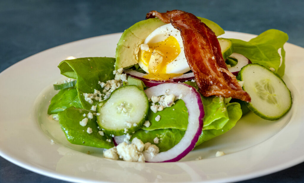 Butter lettuce salad with maple glazed bacon, avocado, Pt. Reyes blue cheese, egg, cucumber, red onion, champagne vinaigrette at Cafe La Haye Wednesday, Oct. 29, 2025, in Sonoma. (John Burgess / The Press Democrat)