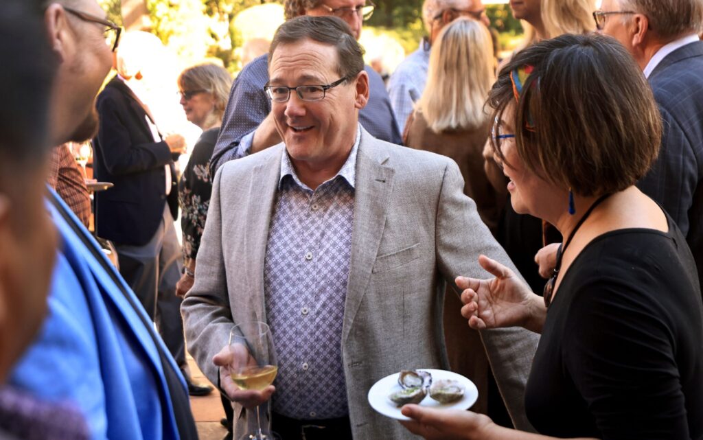 Park Avenue Catering owner Bruce Riezenman talks with friends during a memorial for John Ash at Vinarosa Resort and Spa in Santa Rosa, Saturday, Nov. 1, 2025. (Kent Porter / The Press Democrat)