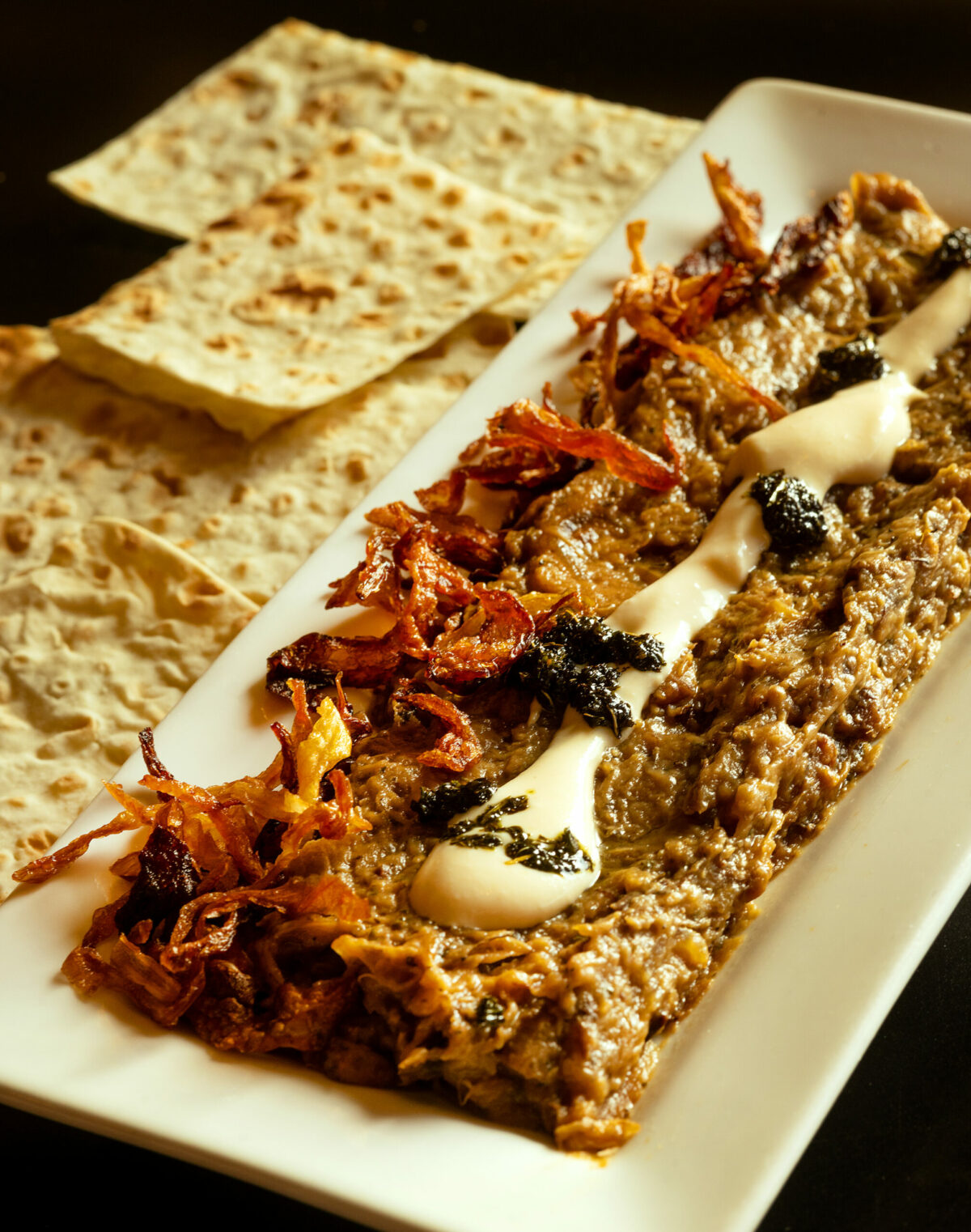 Kasha Bademjan, a roasted eggplant dip with caramelized onion garlic, herbs and creamy kasha with flatbread from the Persian menu, Mondays and Tuesdays at Viva Mēxicana Oct. 29, 2025 in Sebastopol. (John Burgess / The Press Democrat)